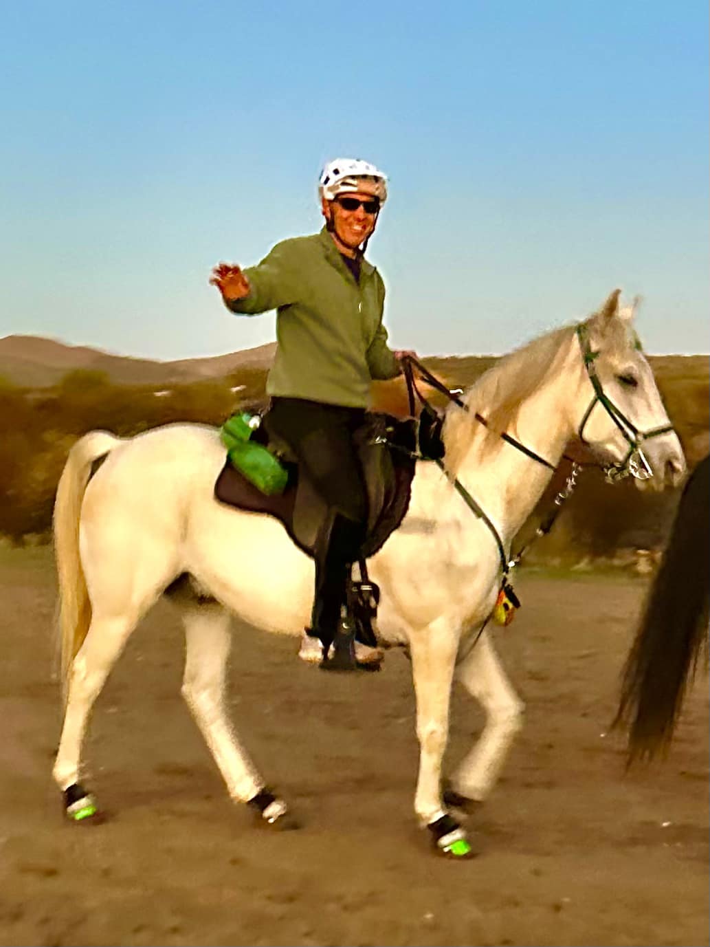 Lucian riding Sandman horse waving