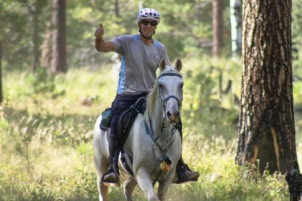 Lucian and horse Sandman riding in the woods